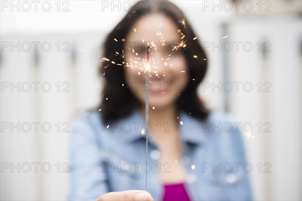 Hispanic woman holding sparkler