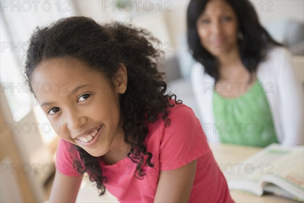 Mother and daughter smiling