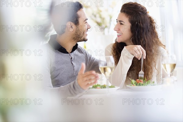 Smiling couple eating at table