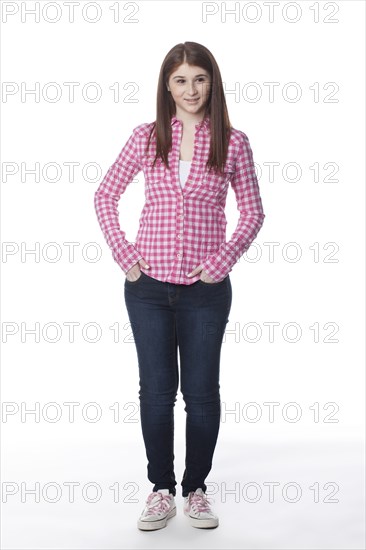 Teenage girl with hands in pockets