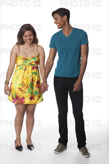 Smiling Hispanic couple holding hands