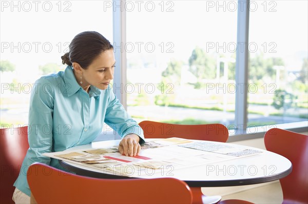 Businesswoman looking at design charts