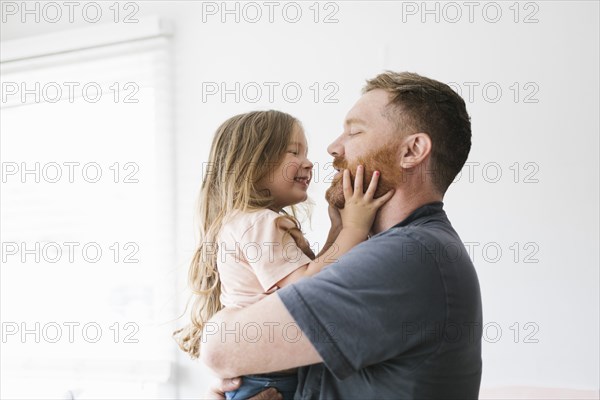 Father holding daughter