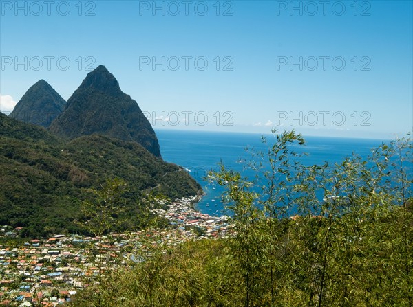 Town in hilly landscape with sea in background, Soufriere, West Indies, St Lucia