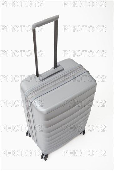 Studio shot of silver rolling suitcase, New York, NY, USA