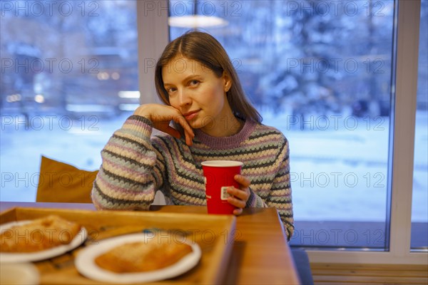 Portrait of woman having breakfast in cafe, Omsk, , Russia