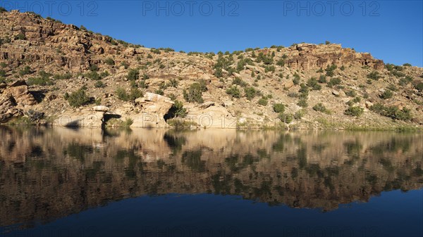 Usa, New Mexico, Abiquiu, Rio Chama, Hills reflected in Chama River, Abiquiu, New Mexico, USA