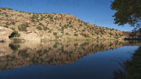 Usa, New Mexico, Abiquiu, Rio Chama, Hills reflected in Chama River, Abiquiu, New Mexico, USA