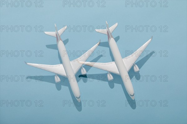 Overhead view of two model planes on blue background, New York, New York, USA