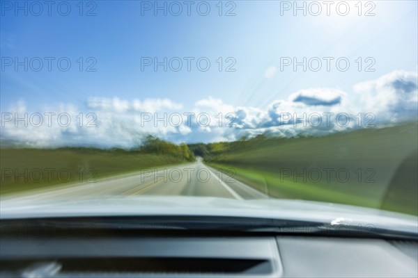 USA, Wisconsin, Country road and clouds seen from moving car, Mt. Horeb, Wisconsin, USA