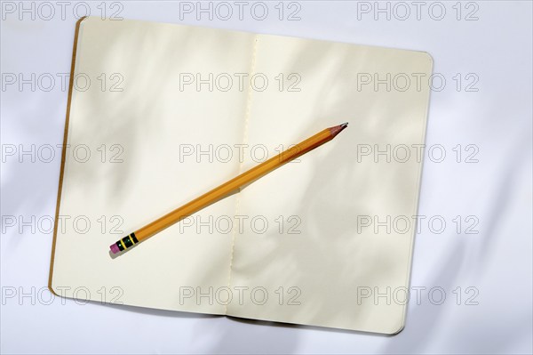 USA, New York State, New York City, Pencil on open note pad on white background, New York City, New York, USA