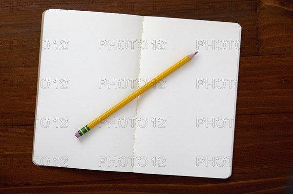 USA, New York State, New York City, Pencil on open note pad on brown background, New York City, New York, USA