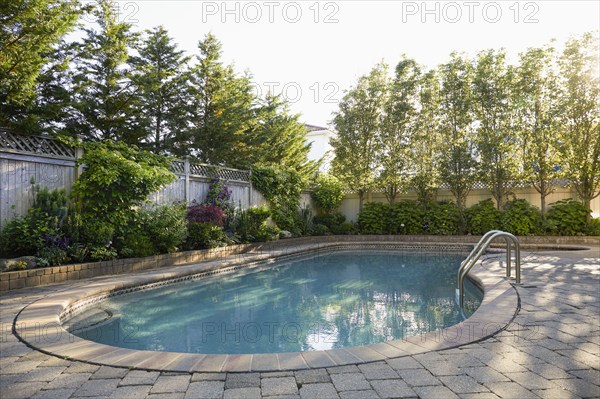 USA, New York, Long Beach, Swimming pool and trees in backyard, New York City, New York, USA