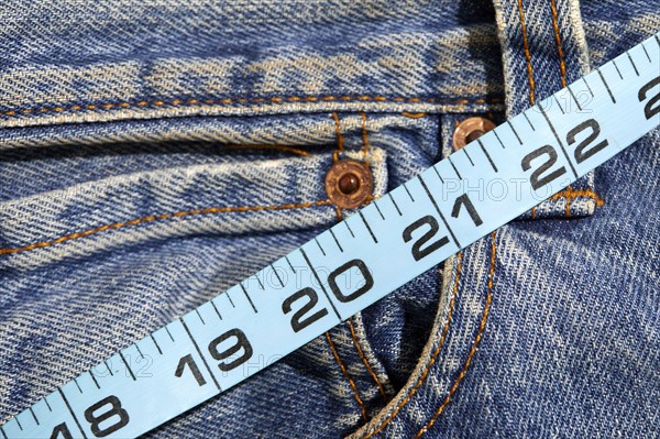 Close-up of tape measure on jeans, New York City, New York, USA