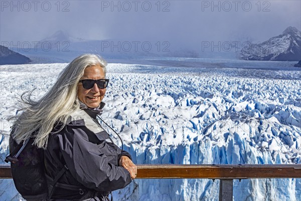 Argentina, Santa Cruz, El Calafate, Portrait of woman at Perito Moreno glacier ice formations, El Calafate, Santa Cruz, Argentina