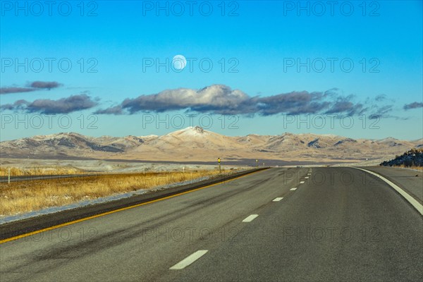 Moon and clouds over empty Interstate 80, Elko, Nevada, USA