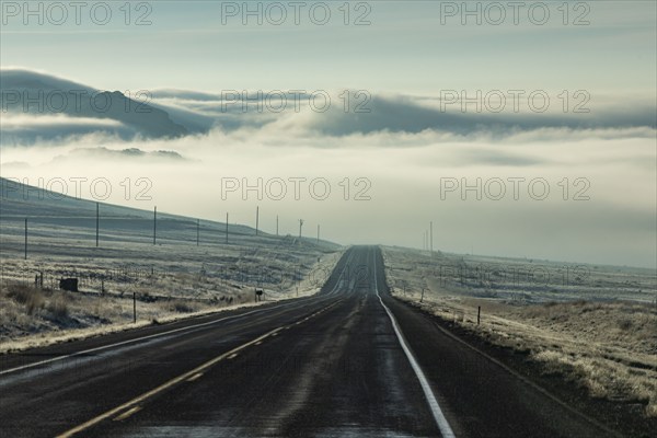 Clouds and fog over empty Idaho 20 road, Mountain Home, Idaho, USA