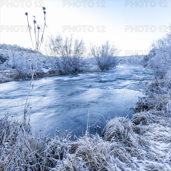 Blue water flowing through frosty high desert landscape, Picabo, Idaho, USA