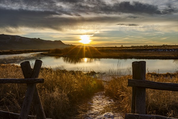 Sunrise over rural spring creek and fields, Bellevue, Idaho, USA