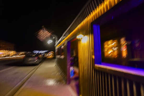 Illuminated building an traffic on street at night, blurred motion, Bellevue, Idaho, USA