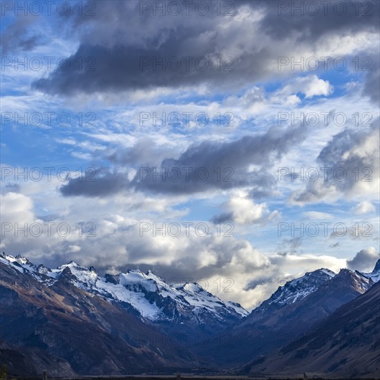 Argentina, Santa Cruz, El Chalten, Clouds above snowcapped peaks surrounding El Chalten, El Chalten, Santa Cruz, Argentina