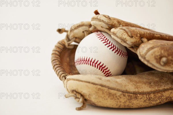 Studio shot of baseball mitt with hard ball
New York City, NY USA