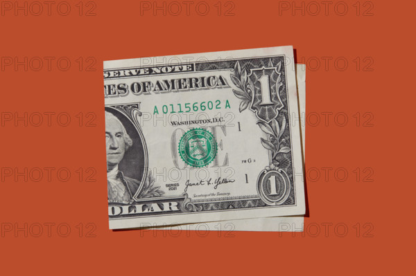 Folded one dollar bill on orange background
New York City, New York State, USA