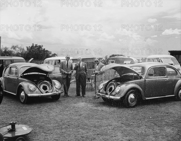 Open bonnet Beetles. Volkswagen Beetles displayed with their bonnets open at the Royal Show. The cars are on show as part of the Cooper Motor Corporation's collection. Nakuru, Kenya, 1 October 1954. Nakuru, Rift Valley, Kenya, Eastern Africa, Africa.