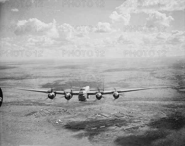 From a Lincoln bomber. Taken from a Lincoln bomber aeroplane, this shot shows a second Lincoln bomber flying over Kenya just after take-off. Kenya, 3 November 1954. Kenya, Eastern Africa, Africa.