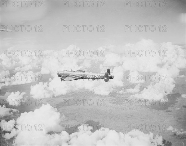 Lincoln bomber in the air. Taken from a Lincoln bomber aeroplane, this shot shows a second Lincoln bomber marked RE299, flying over Kenya. Kenya, 3 November 1954. Kenya, Eastern Africa, Africa.