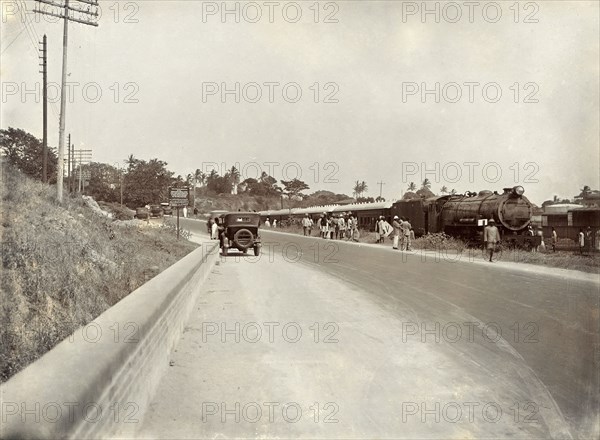 Steam train at a rail siding. View from the road of a steam train, the 'Laconia Special', at a rail siding. Mombasa, Kenya, circa 1930. Mombasa, Coast, Kenya, Eastern Africa, Africa.