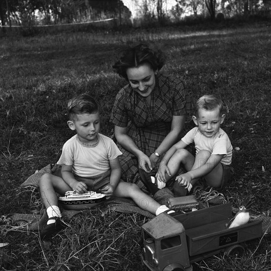 Cecily and children. Cecily Gaueghan playing with her two sons. The boys are playing with some toys. North Kinangop, Kenya, 9-12 February 1953., Central (Kenya), Kenya, Eastern Africa, Africa.