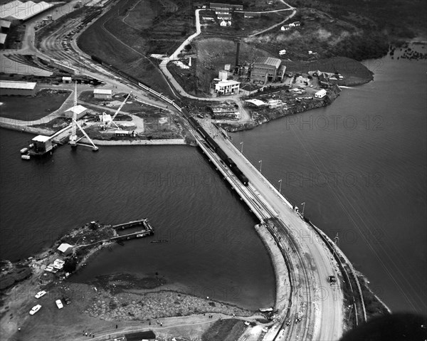 Kipevu Bridge. An aerial publicity photograph from the East African Railways and Harbours Administration (EAR&H) records the passage of the first passenger train over the Kipevu bridge, linking Mombasa Island with the Kenyan mainland. Mombasa, Kenya, 12 August 1960. Mombasa, Coast, Kenya, Eastern Africa, Africa.