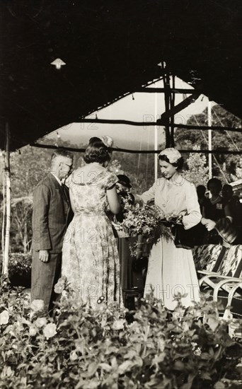 Royal visit to the Peradeniya Royal Botanical Gardens. Queen Elizabeth II is presented with flowers during her visit to the orchid house at Peradeniya Royal Botanical Gardens. The Queen unertook a royal tour of Ceylon (Sri Lanka) between 10 and 21 April 1954. Peradeniya, Ceylon (Sri Lanka), 10-21 April 1954. Peradeniya, Central (Sri Lanka), Sri Lanka, Southern Asia, Asia.