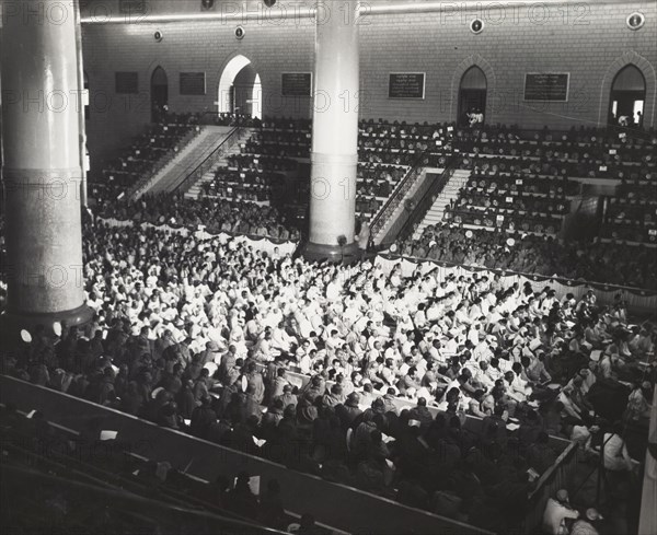 The congregation at the sixth Buddhist Synod. A Buddhist congregation packs out a large hall during the sixth Buddhist Synod in Rangoon. The event was attended by 2,500 Buddhist monks from throughout southern Asia. Rangoon, Burma (Yangon, Myanmar), 1954. Yangon, Yangon, Burma (Myanmar), South East Asia, Asia.