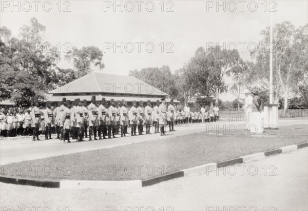 Addressing a regiment of the King's African Rifles. Two European men address a regiment of the King's African Rifles, who stand to attention behind their commanding officer. Uganda, 1936. Uganda, Eastern Africa, Africa.