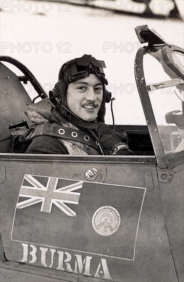 Stanford Tuck in the cockpit of a Hawker Hurricane. RAF flying ace Wing Commander Robert Stanford Tuck sits in the cockpit of a Hawker Hurricane fighter plane wearing flying gear and goggles. Tuck commanded 257 Squadron (also known as the Burma Squadron), which may account for the Burmese flag painted on the fuselage. Location unknown, June 1941.