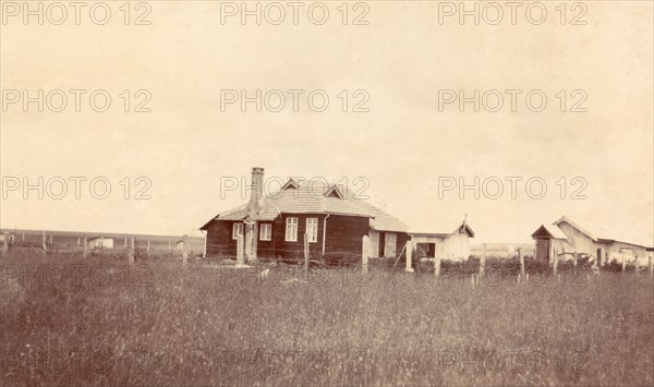 Charles Bungey's house. This timber-framed house was built for Charles Bungey, a training officer with the Kenyan Public Works Department, by the apprentices of his department in March 1922. The apprentices' quarters can be seen in the right background. Nakuru, Kenya, 1922. Nakuru, Rift Valley, Kenya, Eastern Africa, Africa.