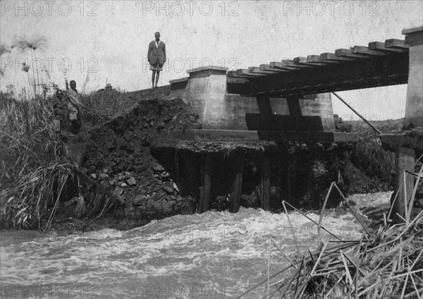 Bridge wash-out. Water rushes underneath a damaged railway bridge on the Thika-Nairobi branch railway near the Fort Hall Road. Kenya, 1921., Nairobi Area, Kenya, Eastern Africa, Africa.