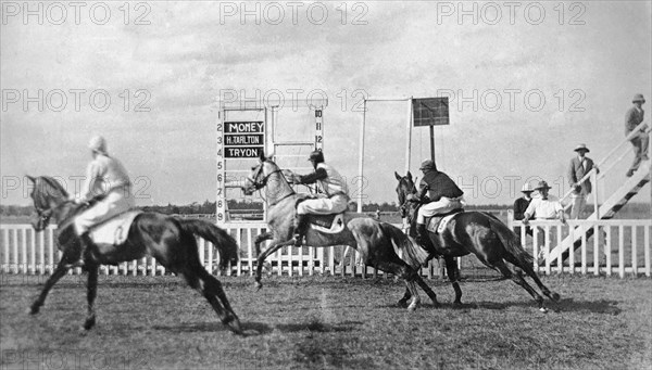 Nairobi horse race. Three horses and their European jockeys (named Money, H Tarlton, and Tryon) cross the start line of the 1? mile race at Nairobi Racecourse. Nairobi, British East Africa (Kenya), February 1919. Nairobi, Nairobi Area, Kenya, Eastern Africa, Africa.