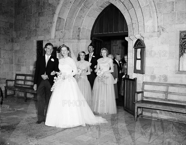 June Watkin's wedding. A wedding party leaves the church, the procession headed by bride June Watkin and her newlywed husband. Kenya, 5 November 1955. Kenya, Eastern Africa, Africa.