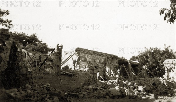 Military hospital after bombardment. The ruins of a military hospital after a bombardment, the remaining walls of which have been propped up with wooden supports. Sudan, circa 1924. Sudan, Eastern Africa, Africa.