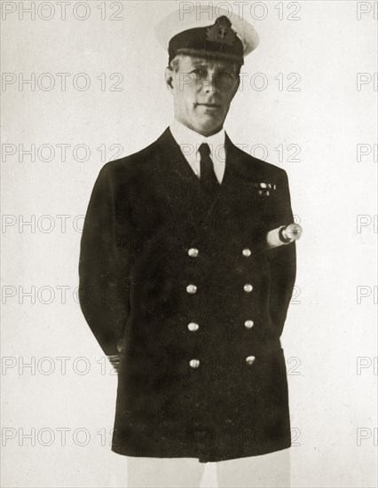 Captain Francis M Austin. Portrait of Captain Francis M Austin, commanding aboard HMS Danae, posed with a telescope tucked under his arm. Location unknown, 1923-4.