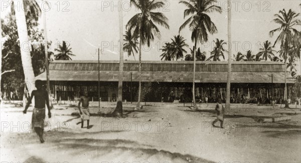 Dar es Salaam market building. An African market building surrounded by tall coconut tress. Dar es Salaam, Tanganyika Territory (Tanzania), 12-17 January 1924. Dar es Salaam, Dar es Salaam, Tanzania, Eastern Africa, Africa.