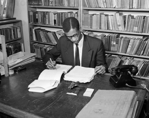 A proof reader at work. Promotional shot for the East African Literature Bureau. An African proof reader checks through the manuscript of a new book. Kenya, 25 September 1956. Kenya, Eastern Africa, Africa.