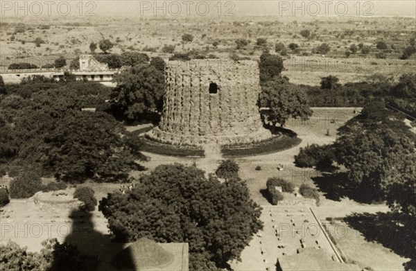 Alai Minar tower. View of the incomplete Alai Minar, taken from the top of the Qutb Minar tower that casts its shadow in the foreground. Delhi, India, circa 1954. Delhi, Delhi, India, Southern Asia, Asia.