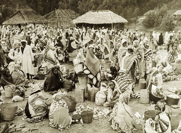 Vegetable market, Tanganyika. An official publicity shot taken for the Tanganyikan government shows women traders sitting on the ground at an outdoors vegetable market, their baskets and produce spread out before them. Tanganyika Territory (Tanzania), circa 1950. Tanzania, Eastern Africa, Africa.