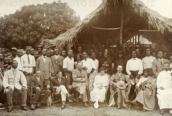 Empire Day with the Mensa of Kumasi. Outdoors group portrait of British and local government and mercantile employees with the Mensa of Kumasi at the 'Native Sports' on Empire Day. Gold Coast (Ghana), circa 24 May 1920. Ghana, Western Africa, Africa.