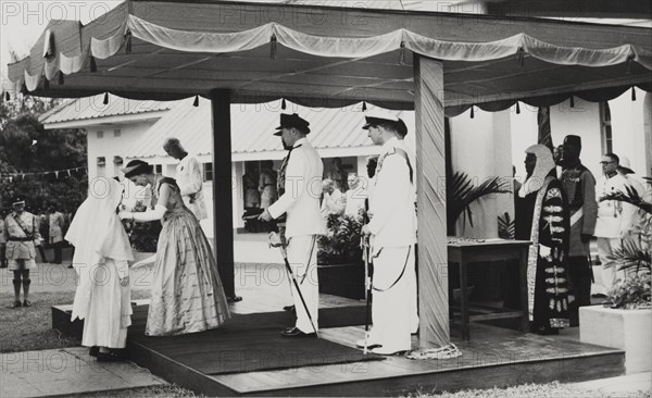 Queen Elizabeth II confers an Honorary OBE. Queen Elizabeth II confers an Honorary OBE to Reverend Mother Mary Osmund of the Roman Catholic Mission, for services to girl's education. The Queen undertook a royal tour of Nigeria with her husband, Prince Philip, Duke of Edinburgh, between 28 January and 16 February 1956. Nigeria, circa January 1956. Nigeria, Western Africa, Africa.