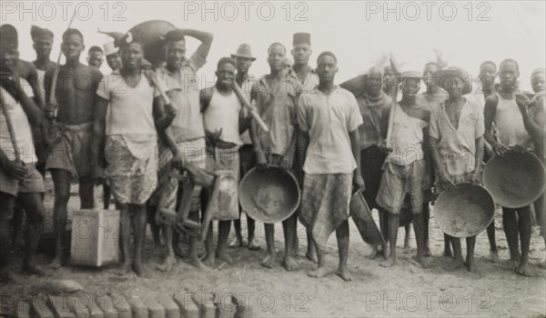 Builders of a new boys' school on the Tana River. A number of young Kenyan men, involved in missionary work to build a new boys' school on the Tana River, take a break to pose for the camera. Coast Province, Kenya, 1951., Coast, Kenya, Eastern Africa, Africa.